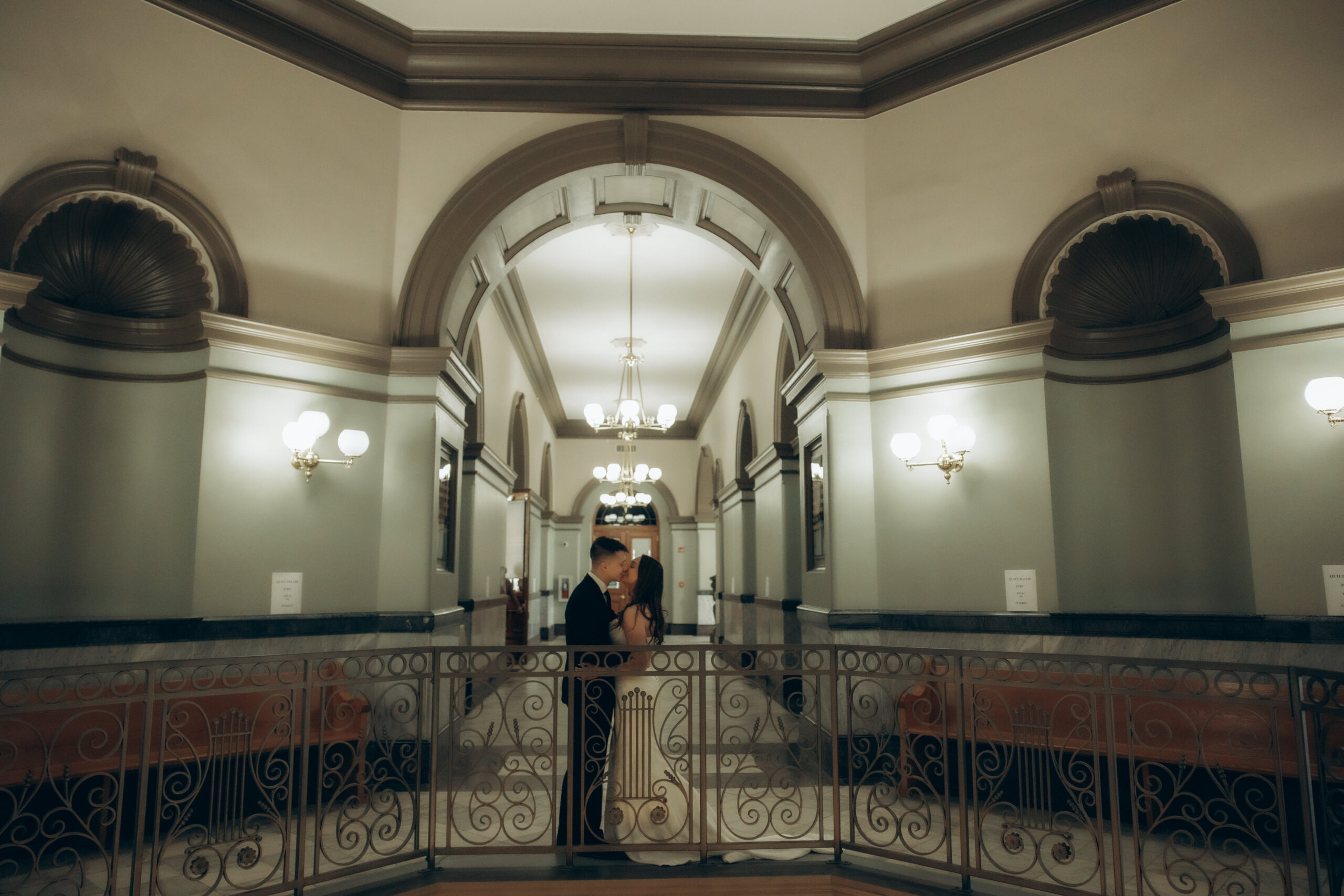 Bride and groom kissing in courthouse before their wedding