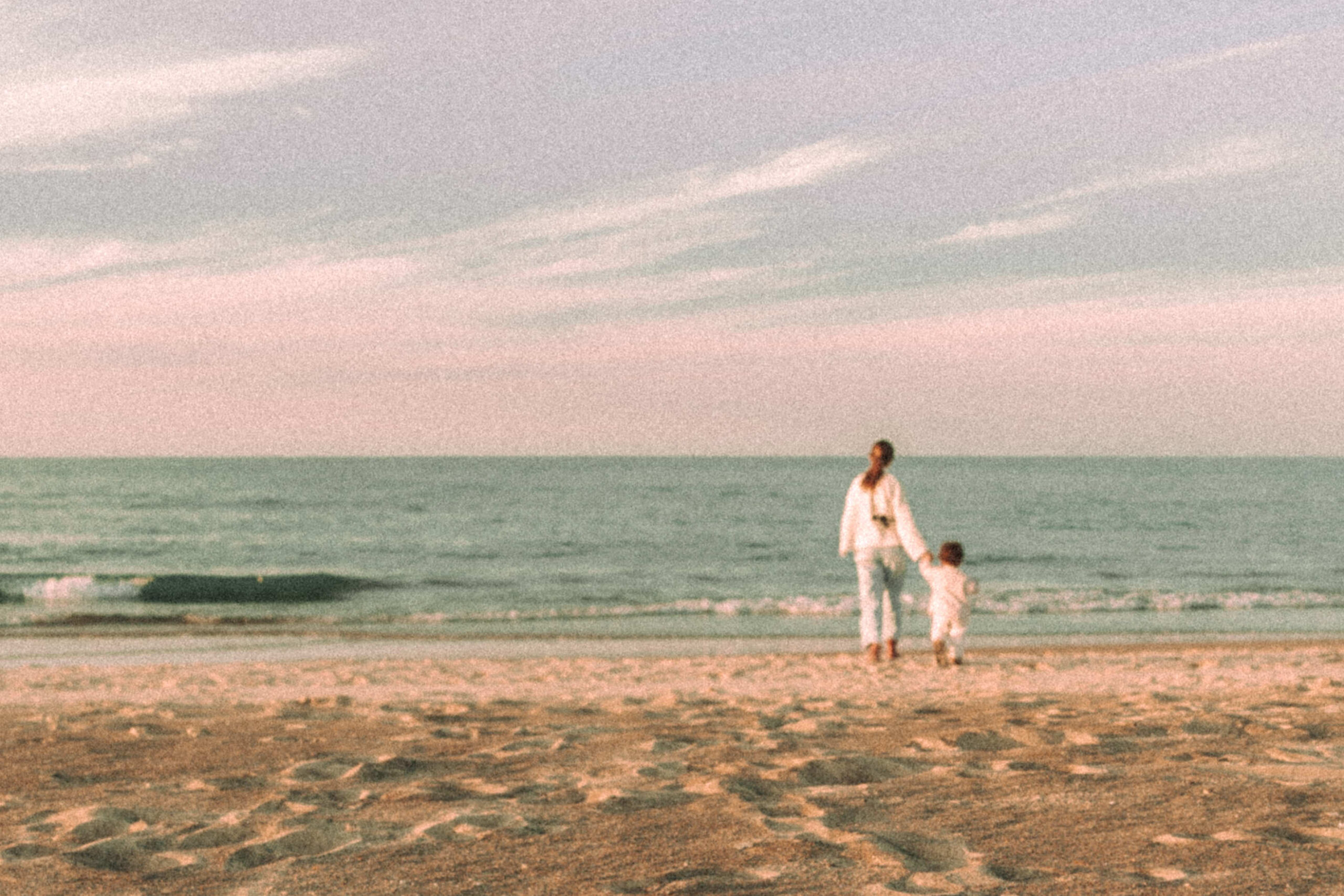 Mother and Daughter holding hands by Lake Michigan