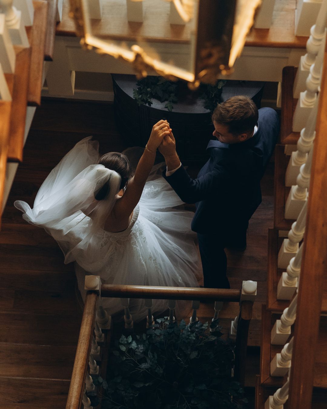 Couple spinning at the bottom of the staircase